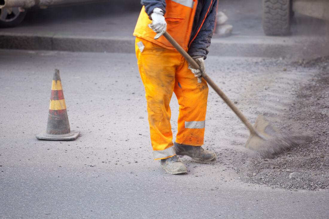 Worker repairing a concrete sidewalk